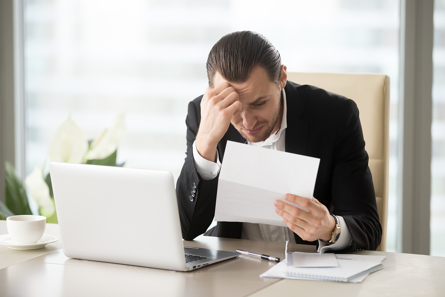 Man holding a paper to file bankruptcy
